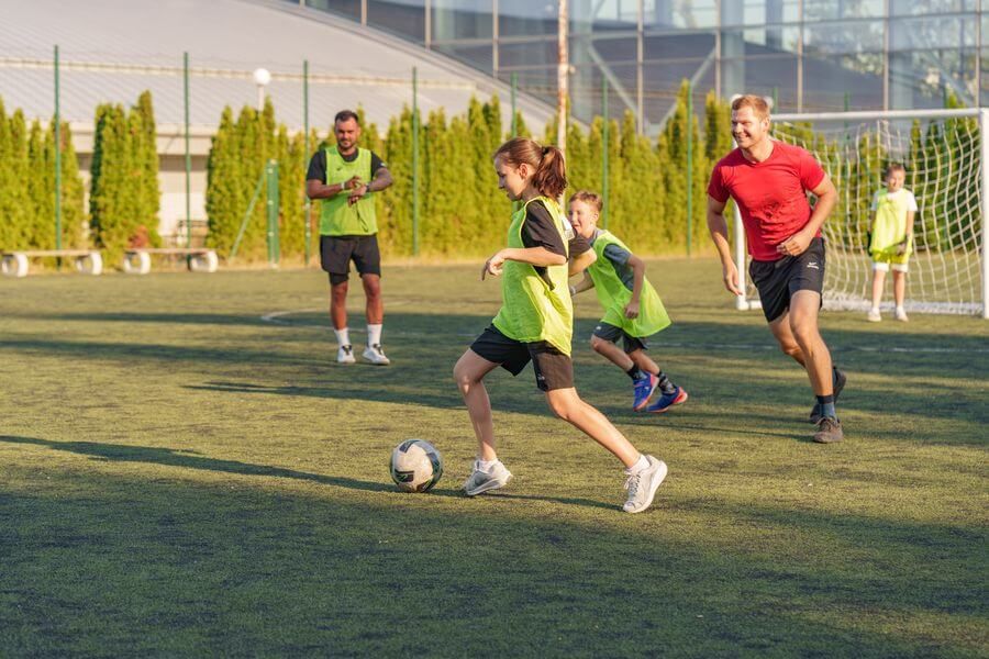 Coaches training campers on the football pitch