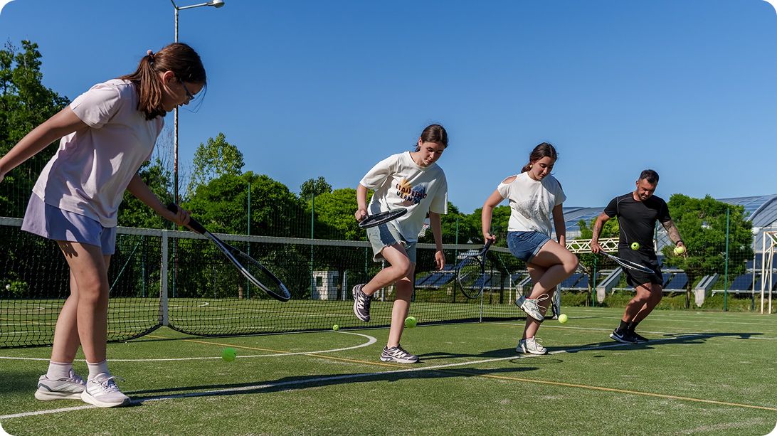 Children playing football during the afternoon track