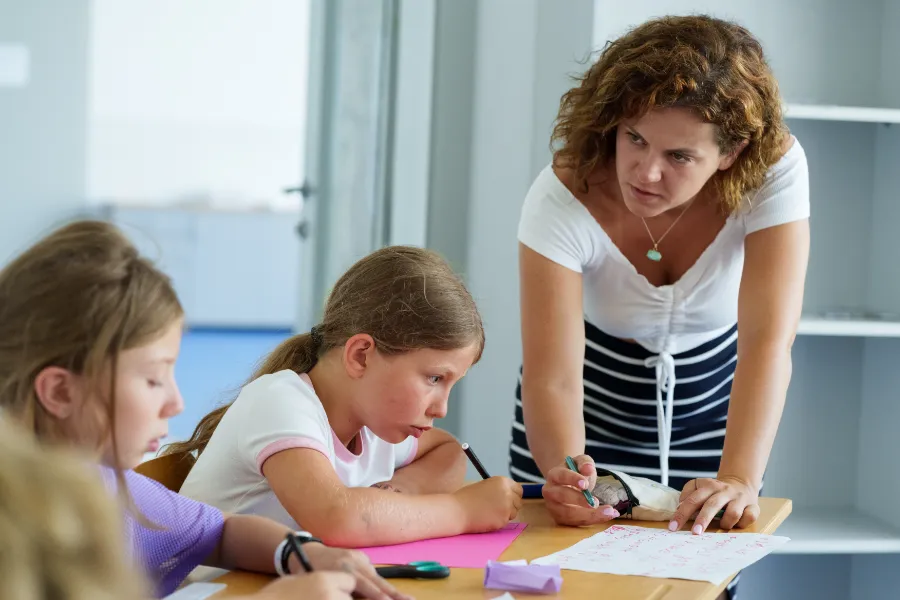 Teacher supporting a student one to one