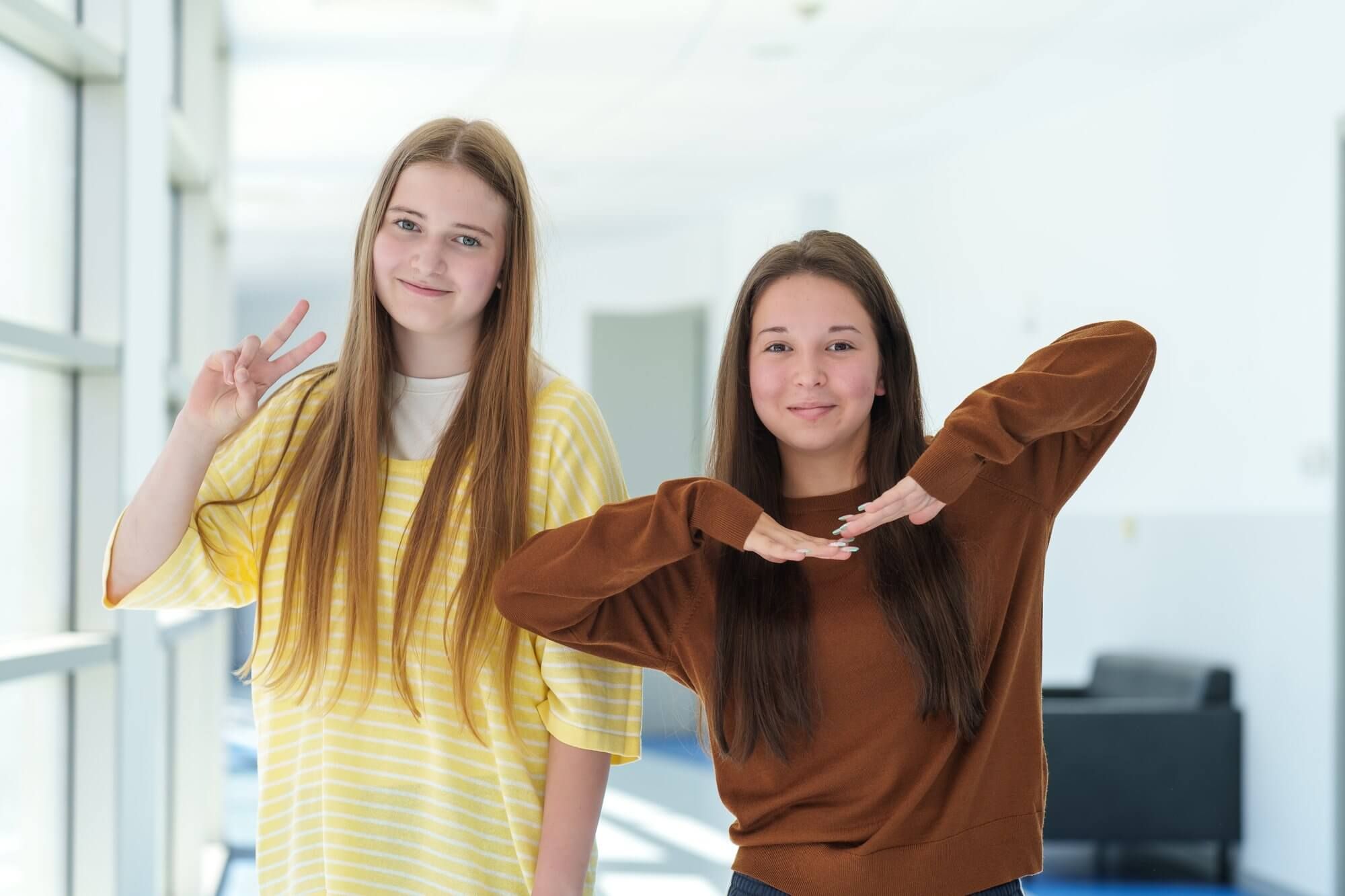 Two girls laughing together in the summer sun at VIEC summer camp 2026