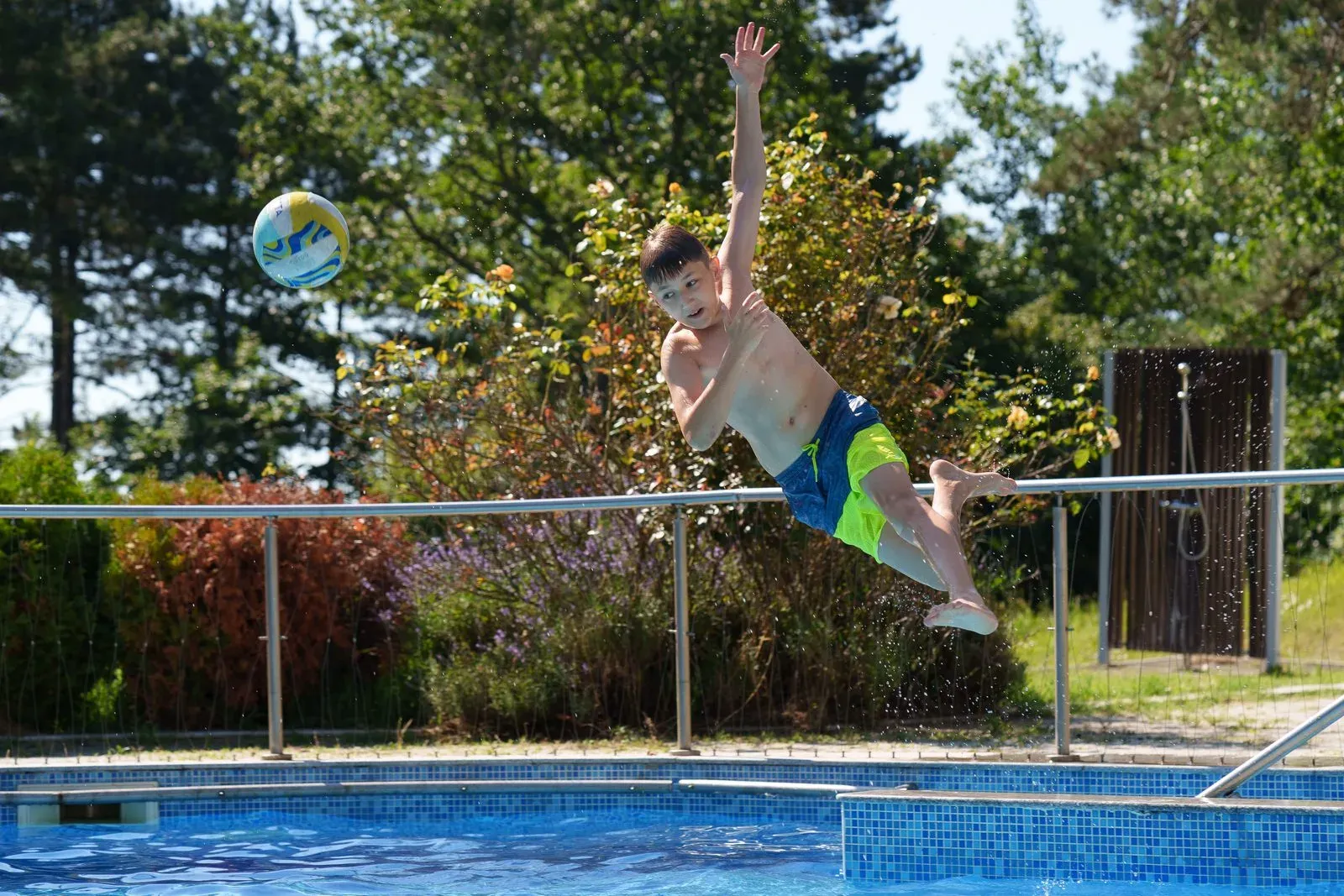 A child jumping into the pool at a summer camp in Bulgaria on the Black Sea coast